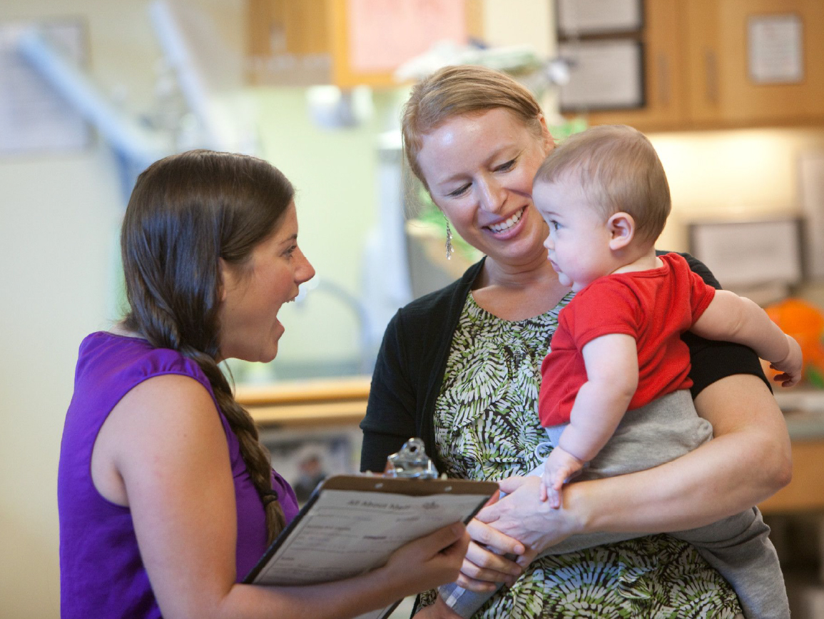 Baby with women at center