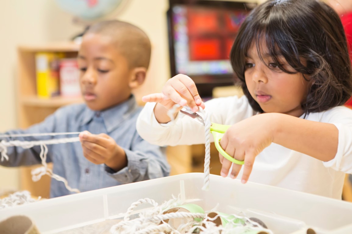 Children playing with box of loose parts