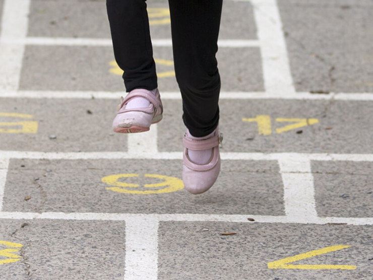 Child playing hopscotch at Bright Horizons day care 