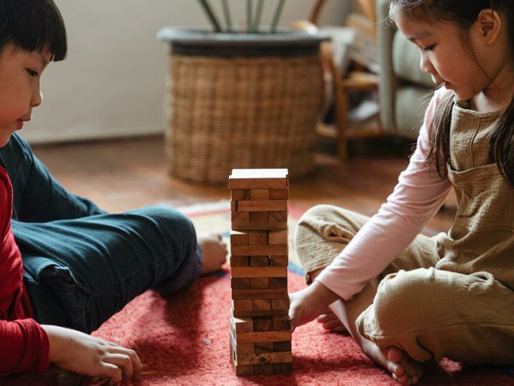 Two children playing jenga at Bright Horizons day care 