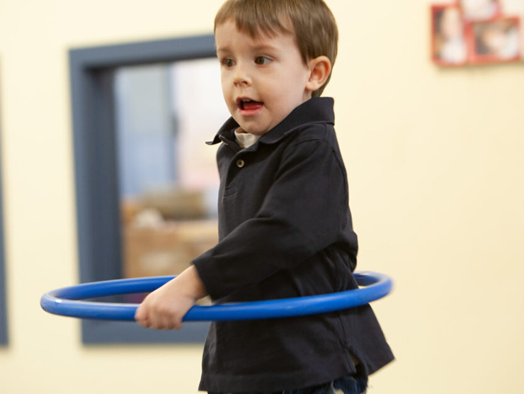 Toddler hula hooping at Bright Horizons day care 