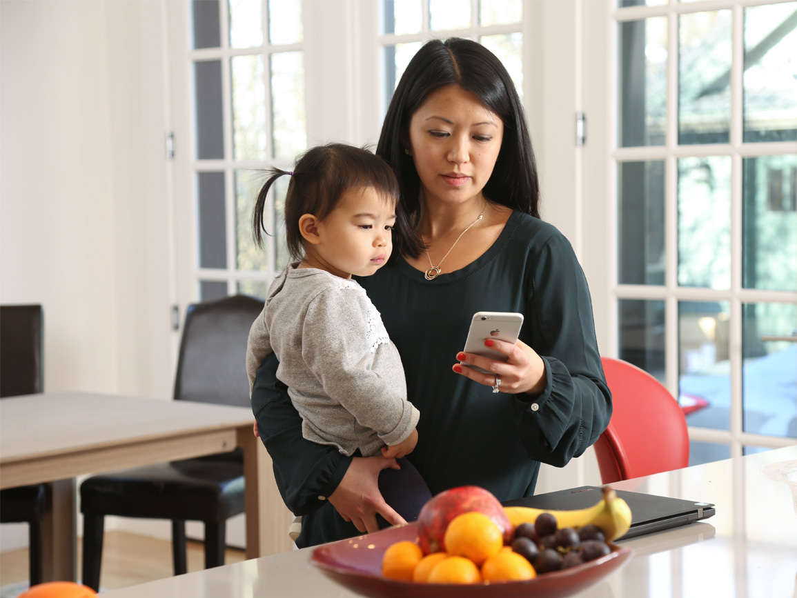 Mom holding child in kitchen