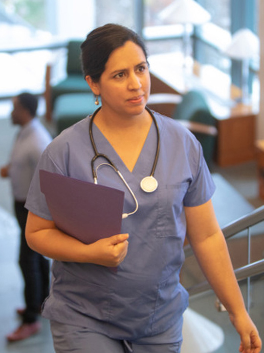 A nurse walking up stairs.