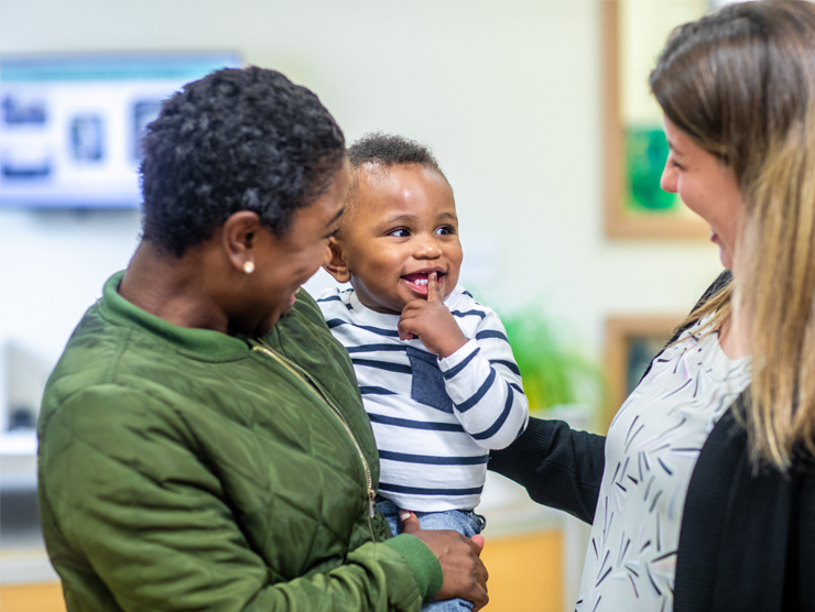 smiling baby with guardian in center