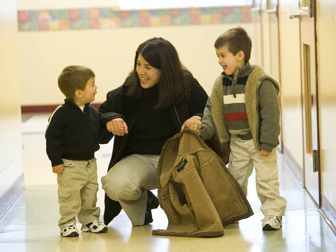 A mother dropping her sons off at their child care center