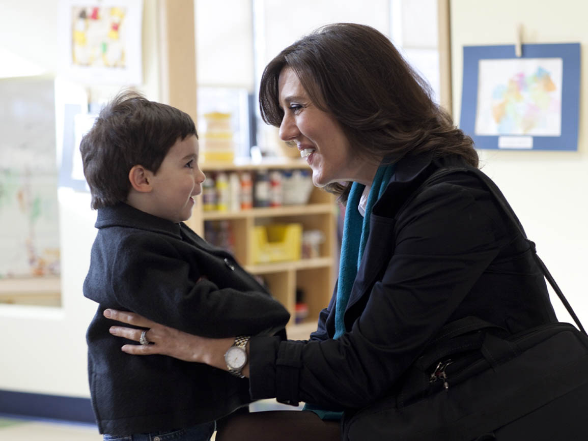 A mother dropping off her son at a child care center