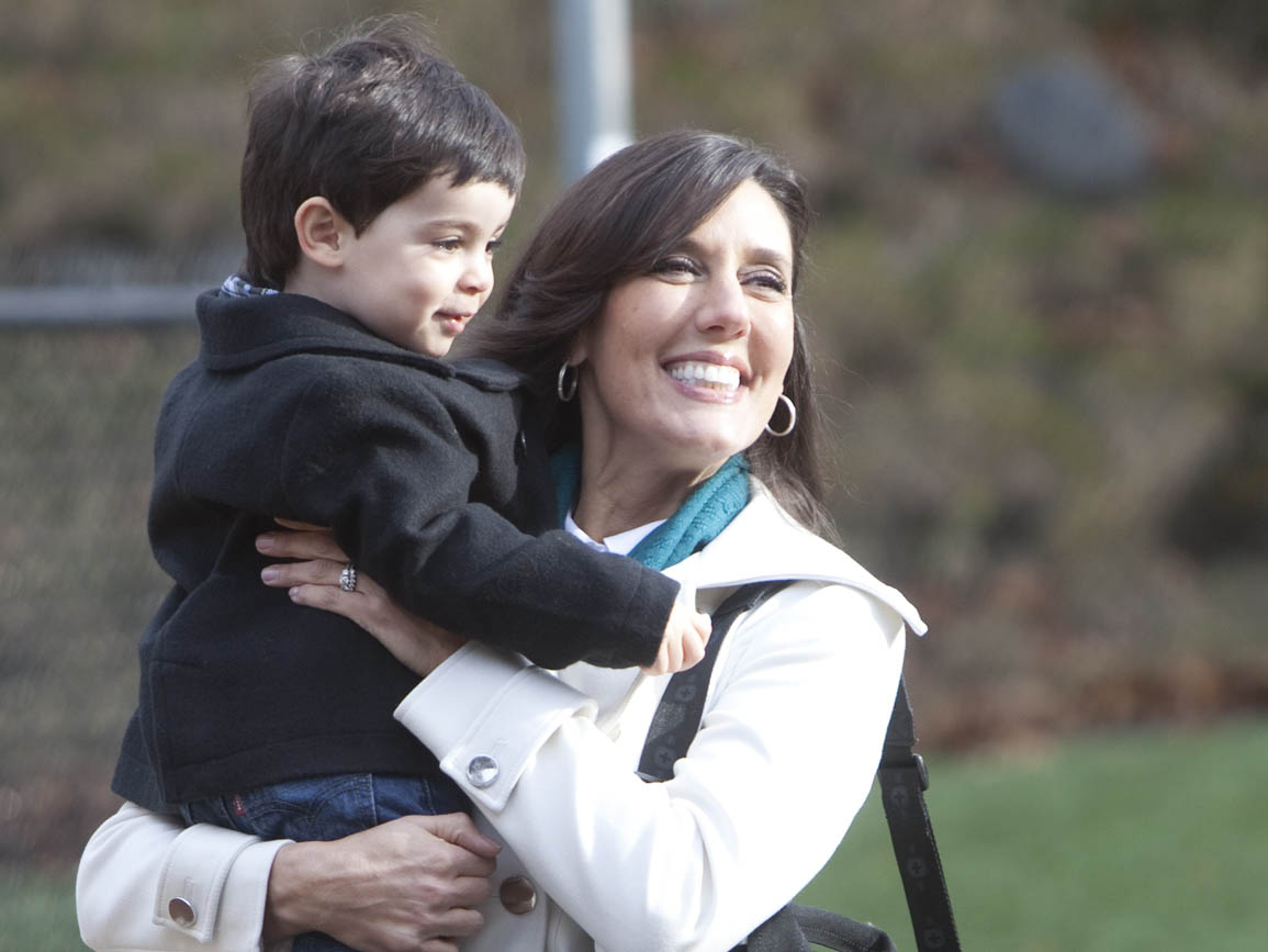 A mother holding her son outside a child care center