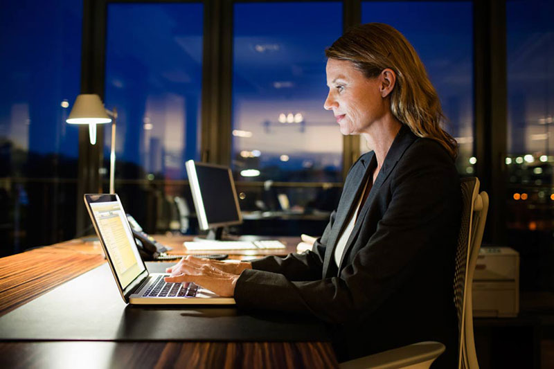 Woman working at night at home