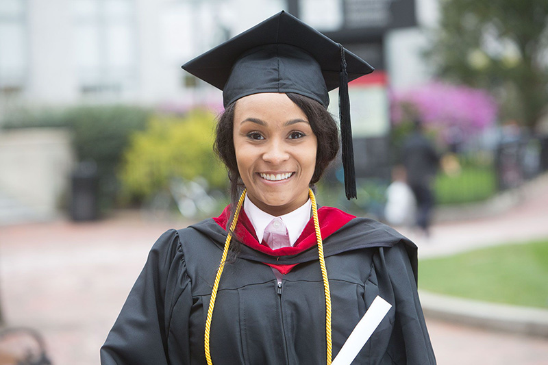 Adult learner in a graduation cap and gown