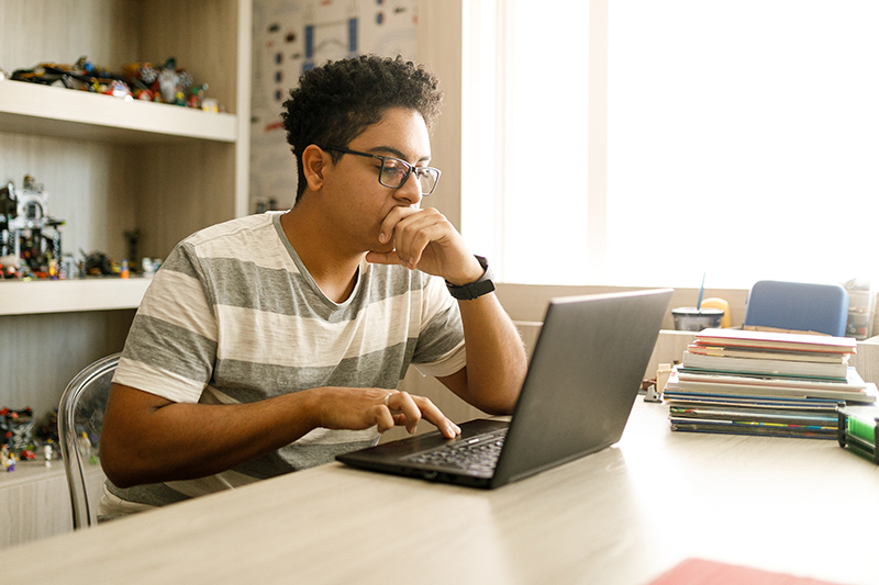 Young employee using education benefits at home