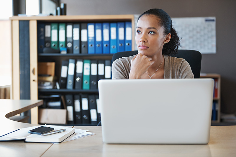 Young professional at work thinking about student loan forgiveness