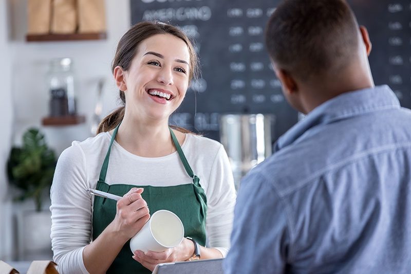 Barista frontline employee working during the holiday season