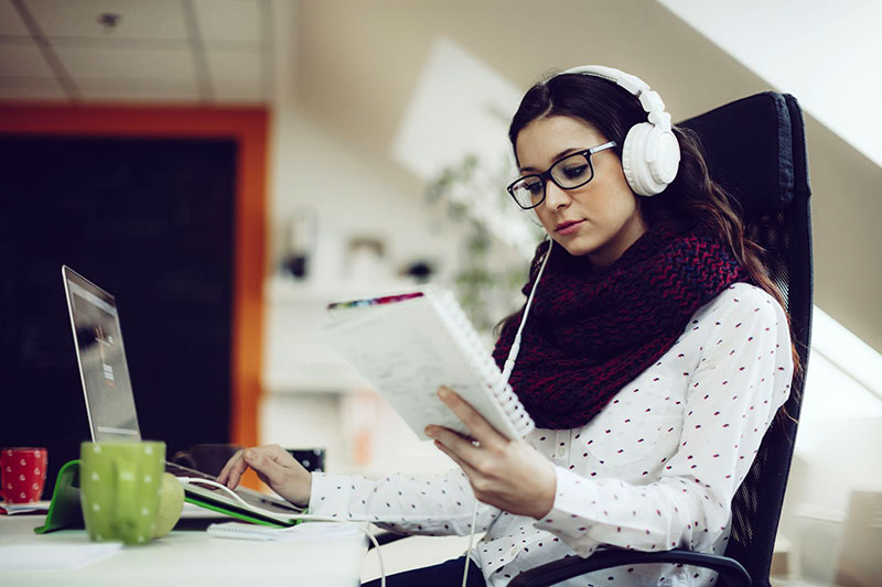 A millennial woman sitting at her desk