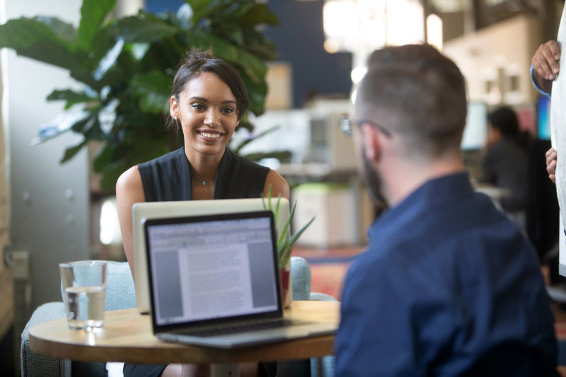 Two young professionals studying for their no cost, free degree program