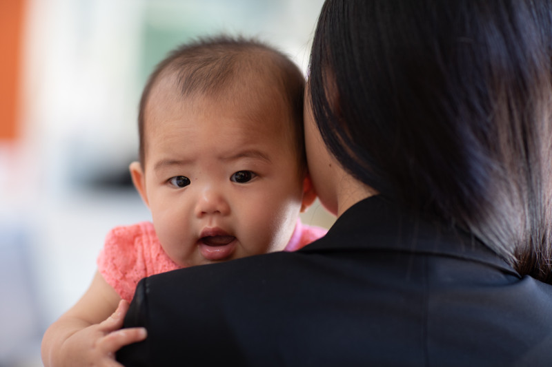 Working mom holding her infant