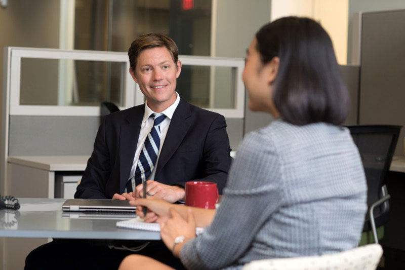 Young professional discussing a tuition assistance program with her manager