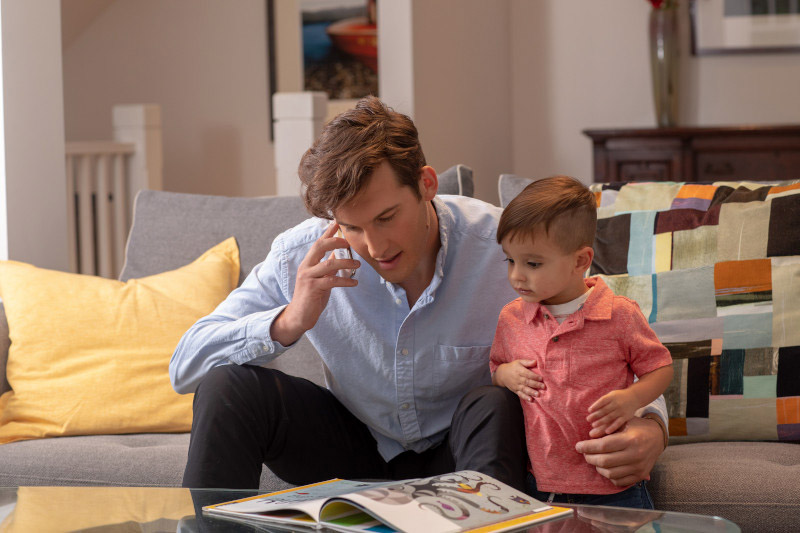 Dad juggling work and child care at home