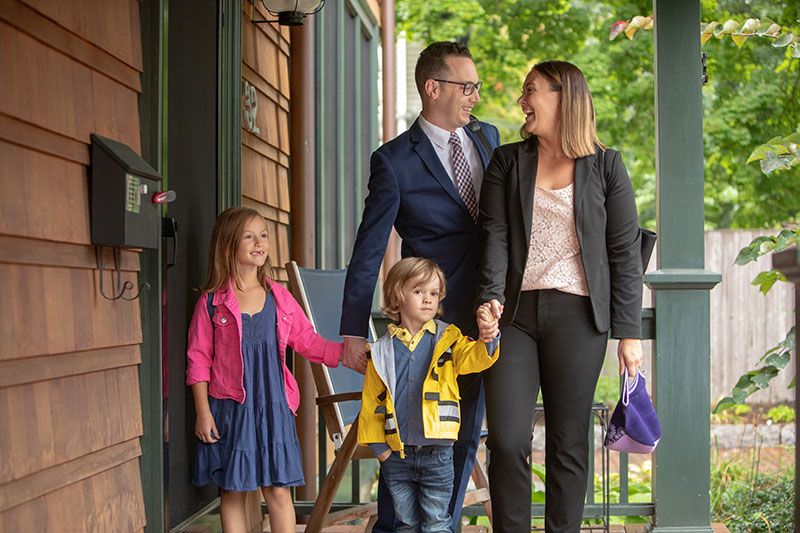 Mom, dad, and two young children leaving for work and school