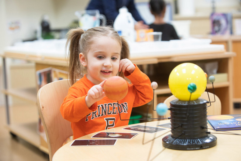 Preschooler doing STEM activity at an on-site child care center