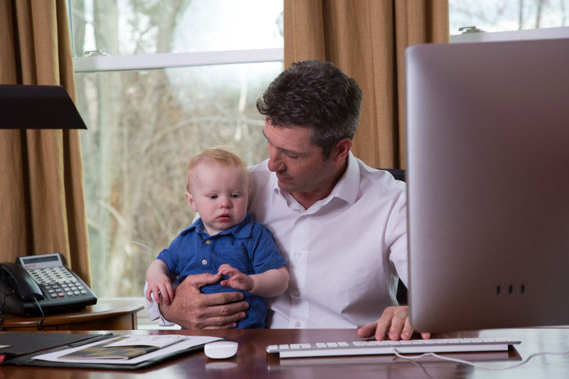 Working dad caring for infant during the summer