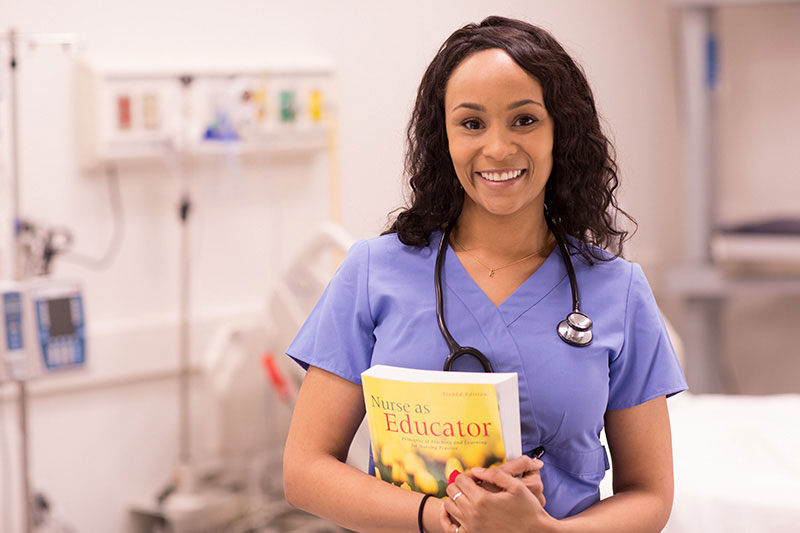 Nurse holding a text book