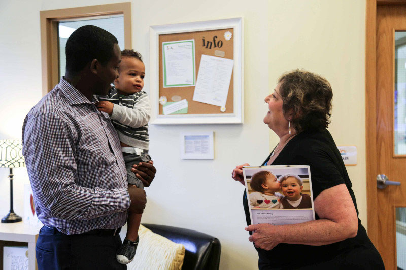 Working dad dropping son off at employer sponsored child care center