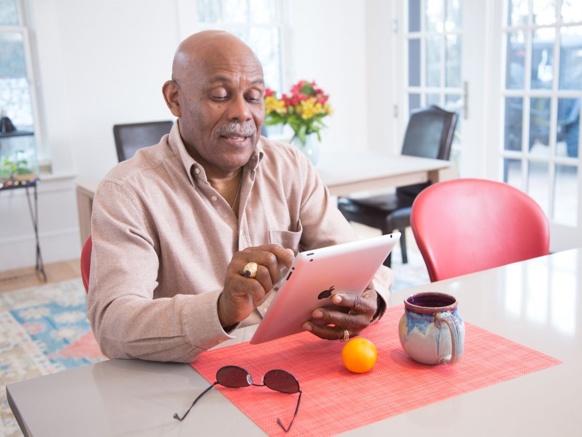 elderly man keeping his skills sharp by using a tablet computer