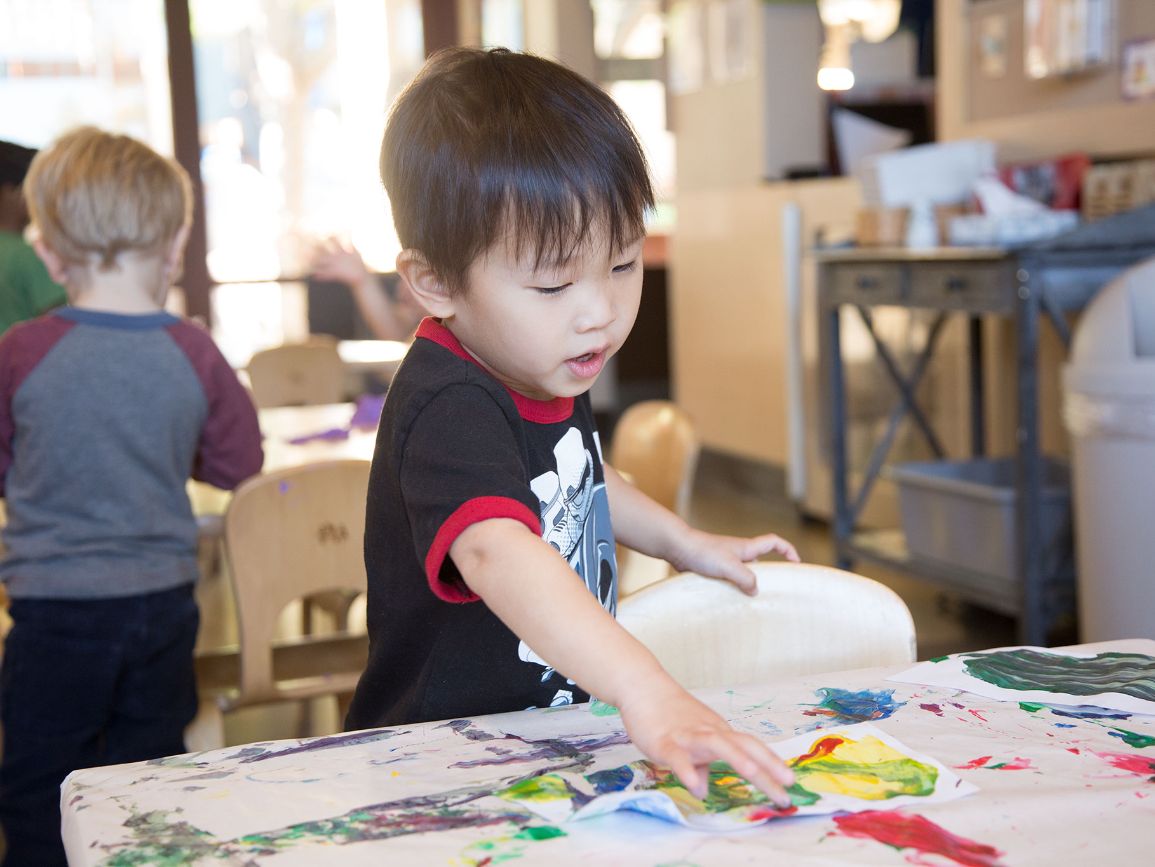 Preschool boy playing at an art table