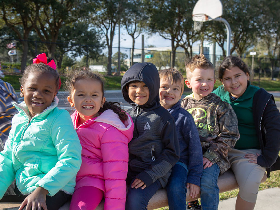 Group of young children doing outside activities in the winter