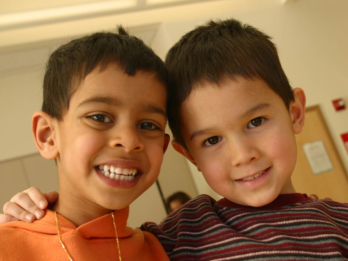 two toddler friends smiling together