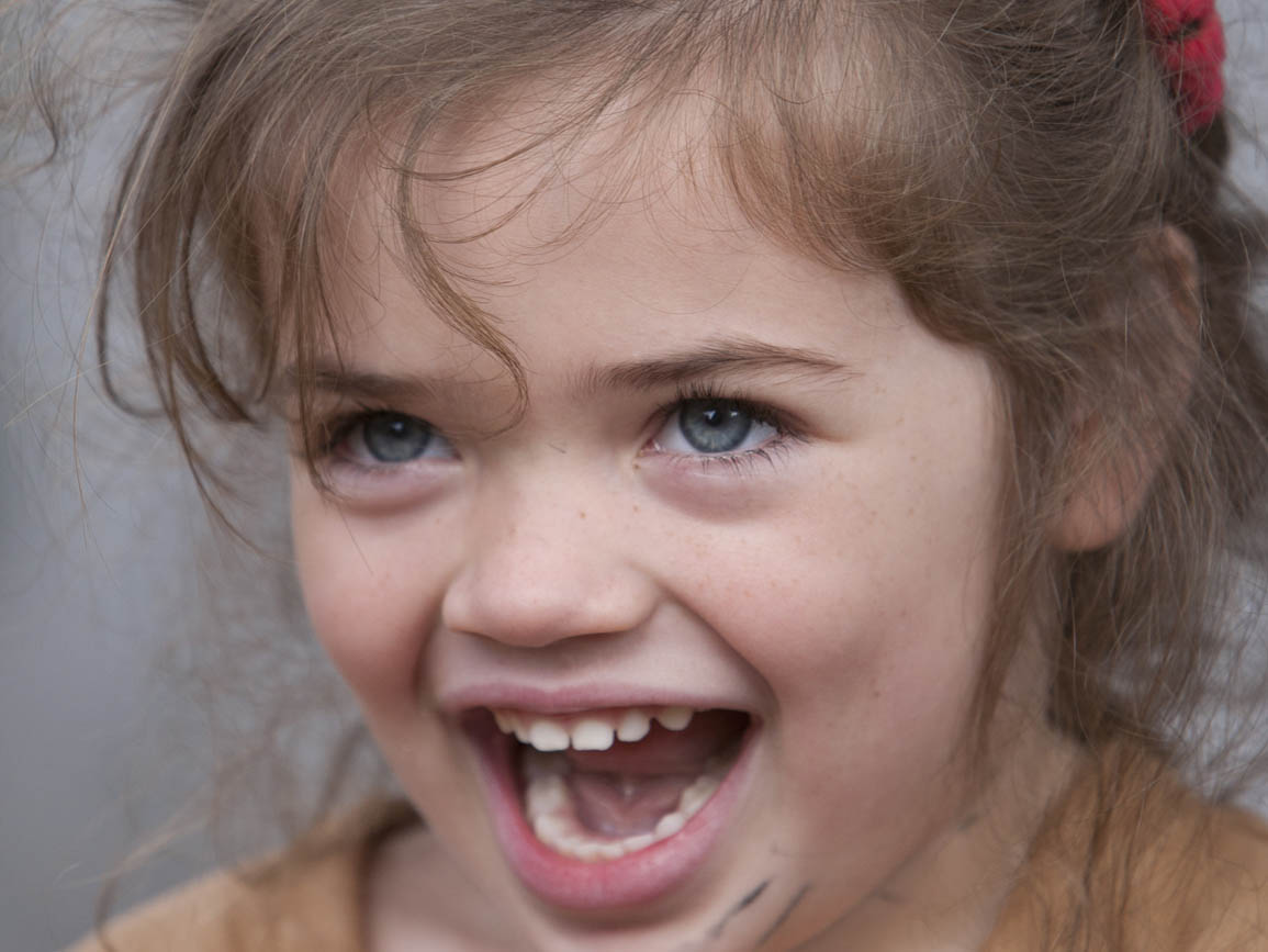 A toddler girl opening her mouth wide