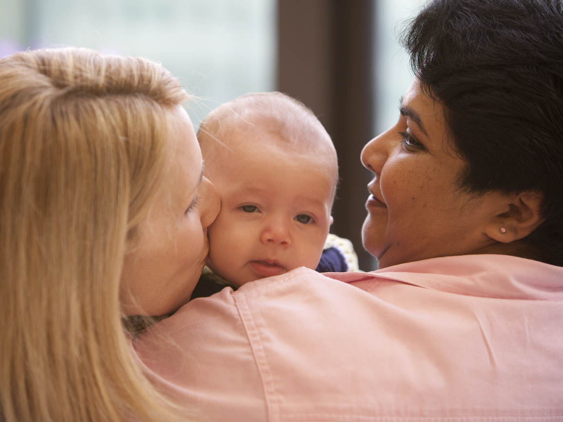 A mother with her infant and their babysitter