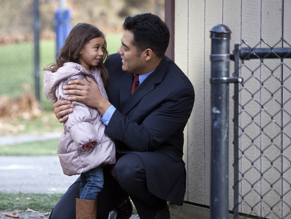 A dad dropping off his daughter at daycare