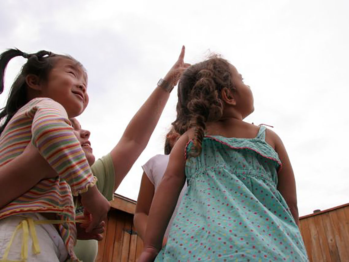 Toddler girls watching the sky