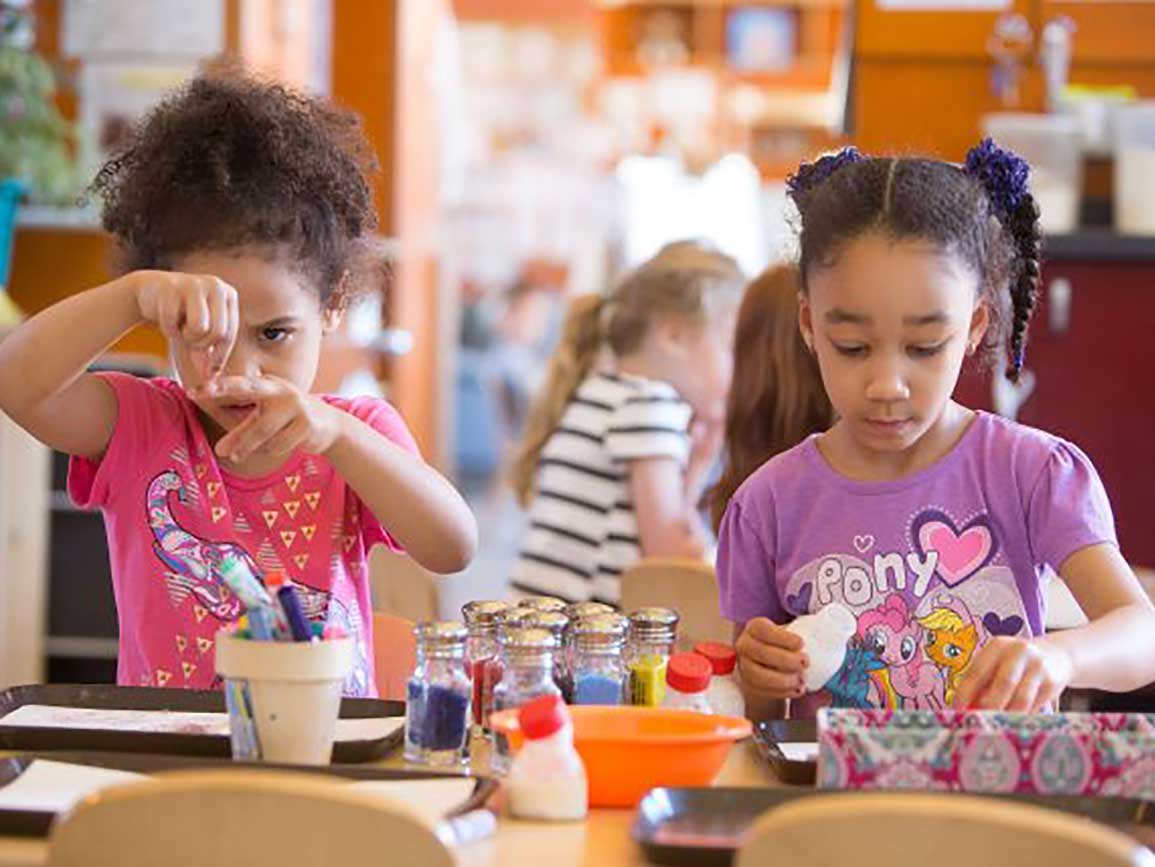 School-aged girls playing at a table