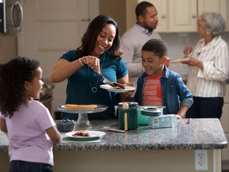 Family eating the Thanksgiving pie they made together||