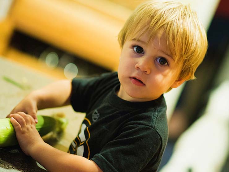 Toddler boy with a mischievous look on his face|Toddler boy with ear of corn|Toddler boy in the snow