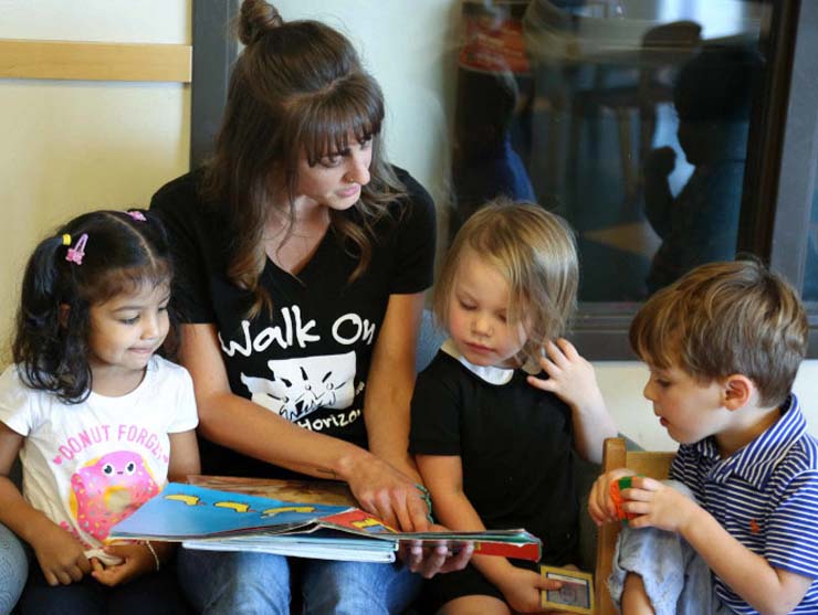 Teacher reading black history books for kids to preschoolers