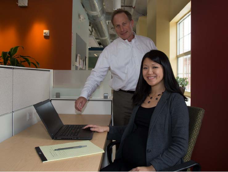 Pregnant Mother at work|pregnant woman in a meeting at work