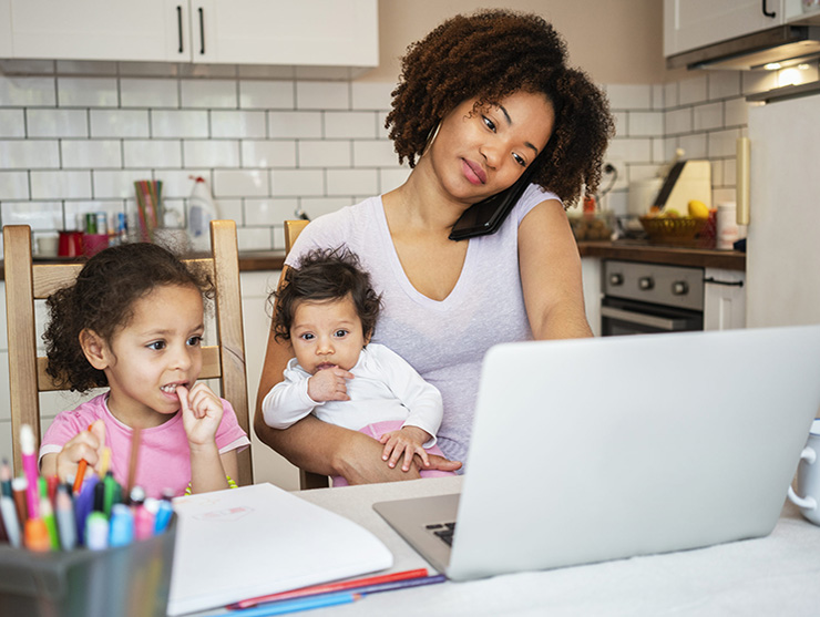 Mom trying to work while entertaining her two young children